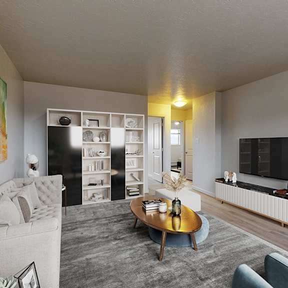 a living room with a grey couch, a coffee table, and a painting on the wall.