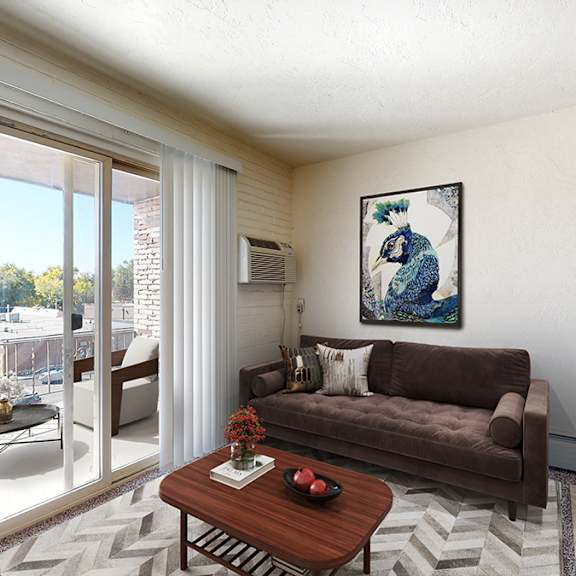 a living room with a brown couch, a coffee table, and a painting on the wall.