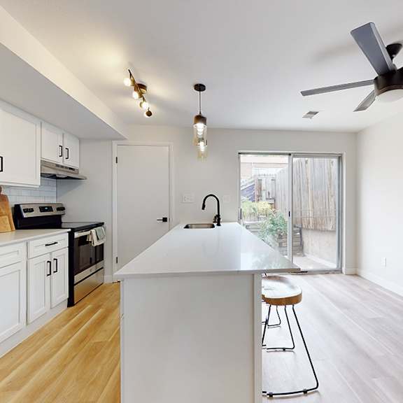 a kitchen with white cabinets and a white fridge.
