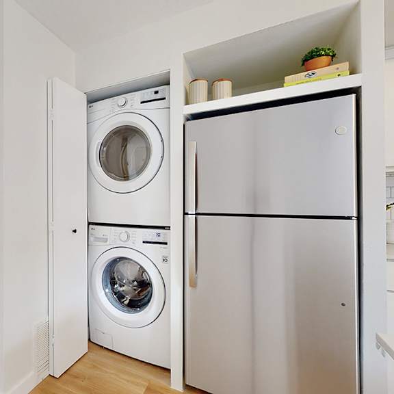 a white laundry room with a washer and dryer in it.