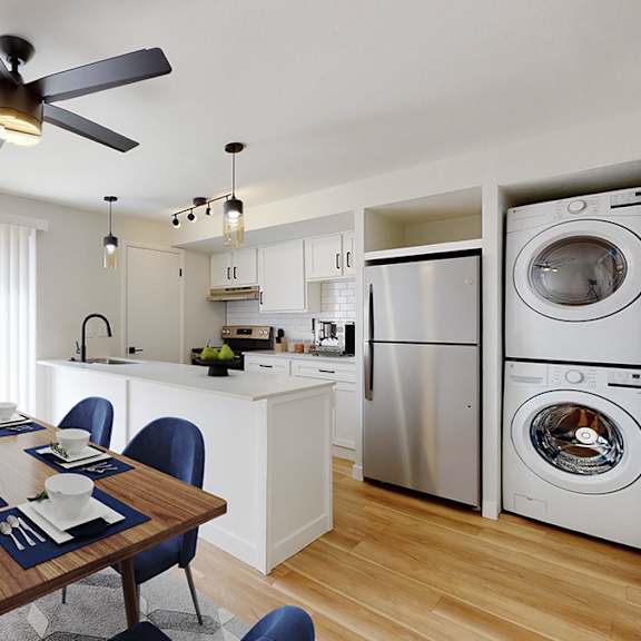 a modern kitchen with a dining table set for six.