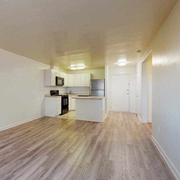 a kitchen area with a refrigerator, microwave, and oven.