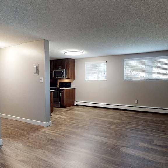 a room with wooden floors and white walls.