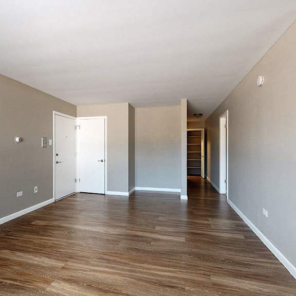 a long hallway with doors on both sides.