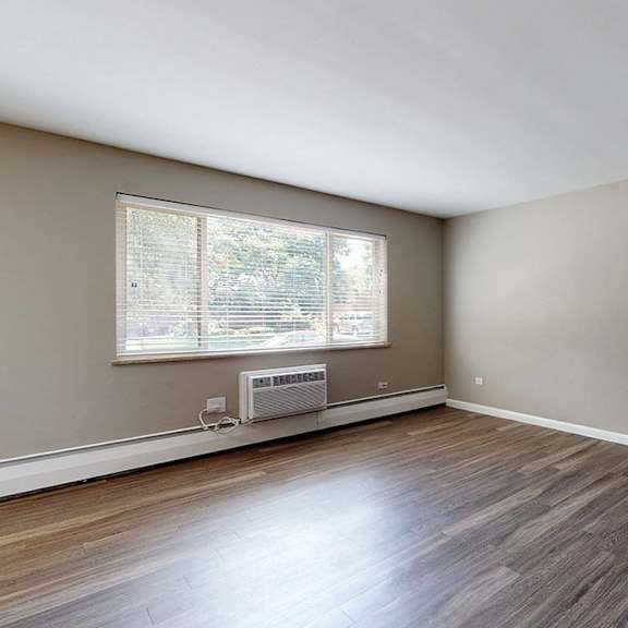 a room with a window and a fan on the wall.