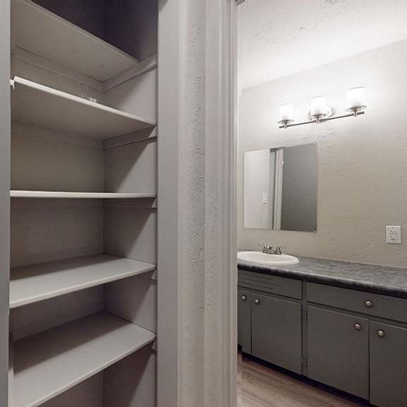 a bathroom with a large mirror and a vanity with a sink.