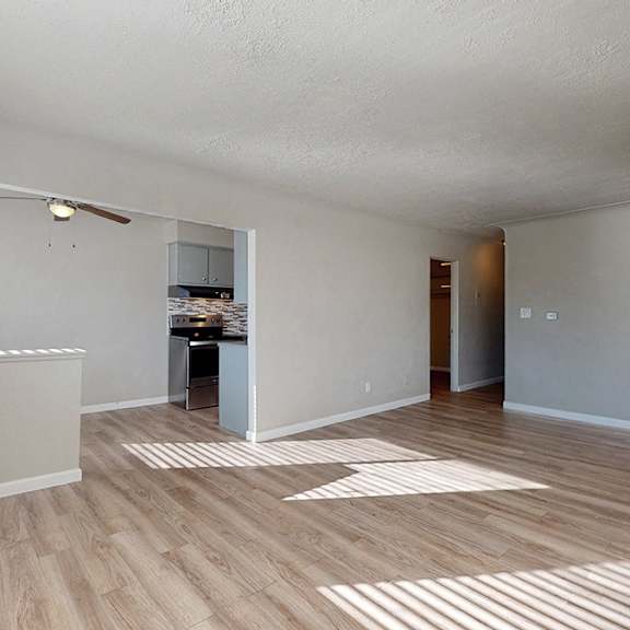 a room with wooden flooring and a ceiling fan.