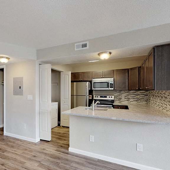 a kitchen area with a countertop and a microwave.