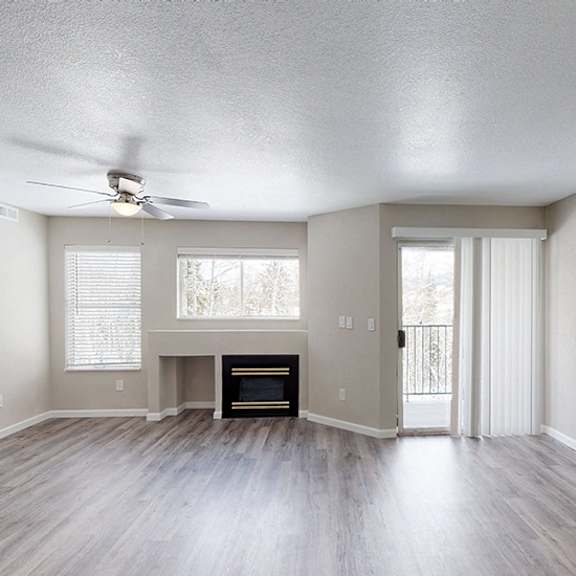 a living room with a fireplace and sliding glass doors.