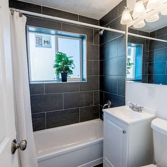 a bathroom with a white toilet and a white sink.