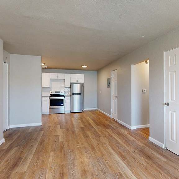 a room with wooden floors and white walls.