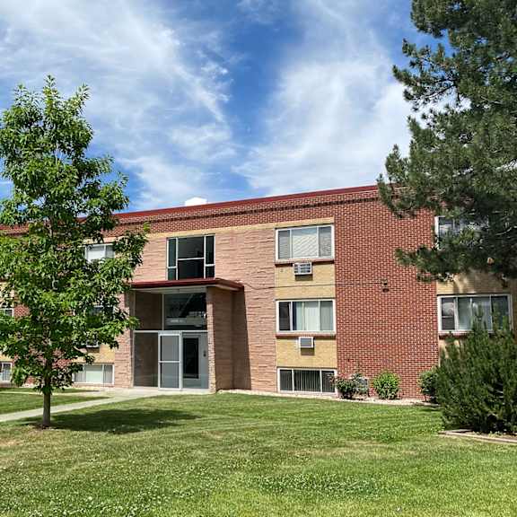 south majestic apartments showing a red brick building with a tree in front of it.