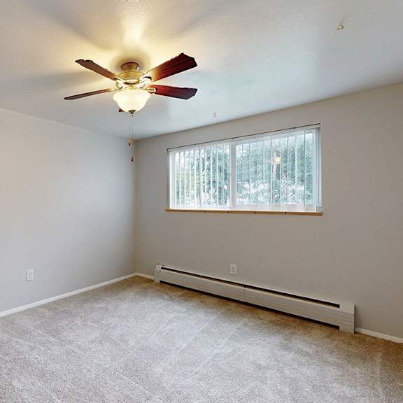bedroom with carpeting, a ceiling fan and a window with blinds.