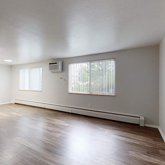 living area with wooden floors and white walls.