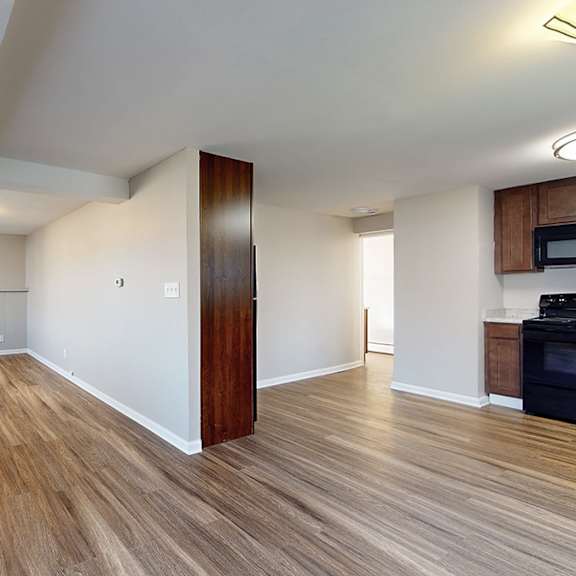 a room with wooden floors and white walls.