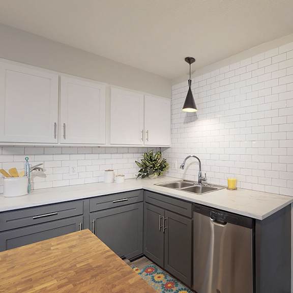 a kitchen with a wooden table and a stainless steel dishwasher.