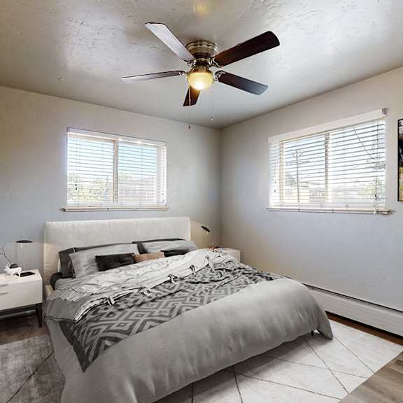 a bedroom with a bed, a ceiling fan, and a window with blinds.