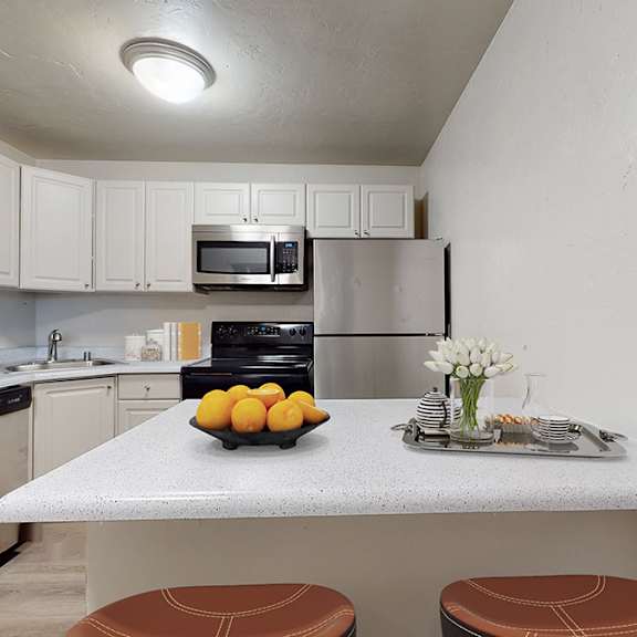a kitchen with a table and chairs in the middle.