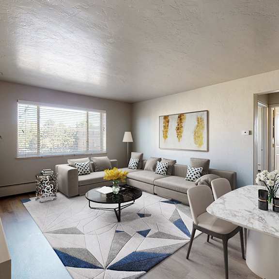 a living room with a couch, chairs, and a coffee table.
