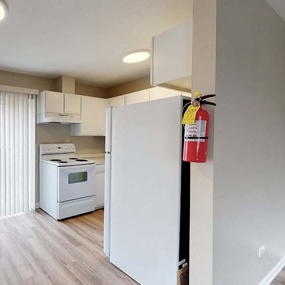 a kitchen with a white fridge and a white oven.
