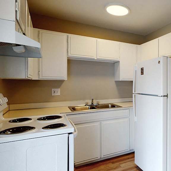 a kitchen with white appliances and cabinets.