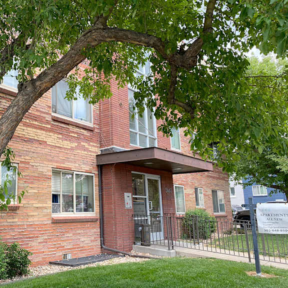 a tree in front of a brick building with a sign that says "southpointe villas".