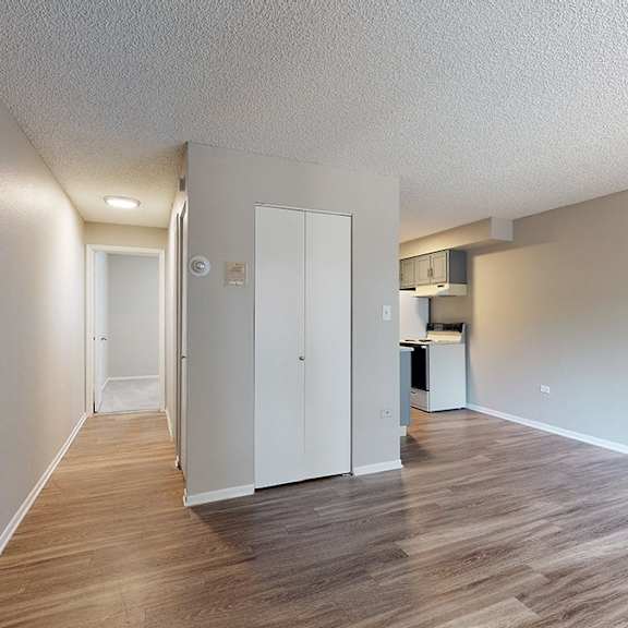 a room with a white door and a white cabinet.