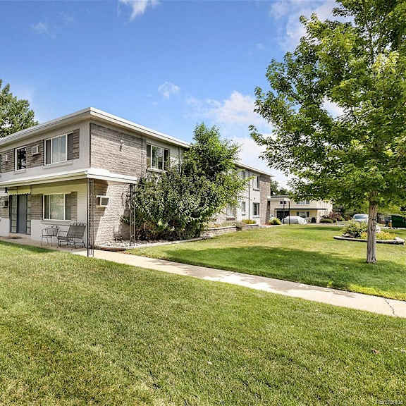 a house with a well-maintained lawn in front.