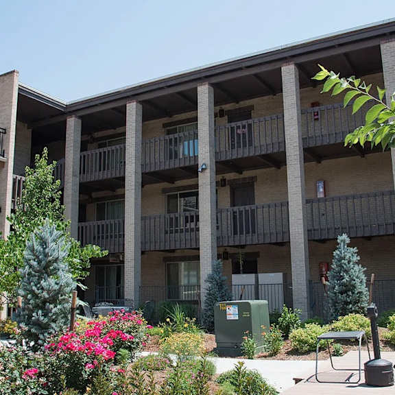a sunny day at a residential complex with a clear blue sky.