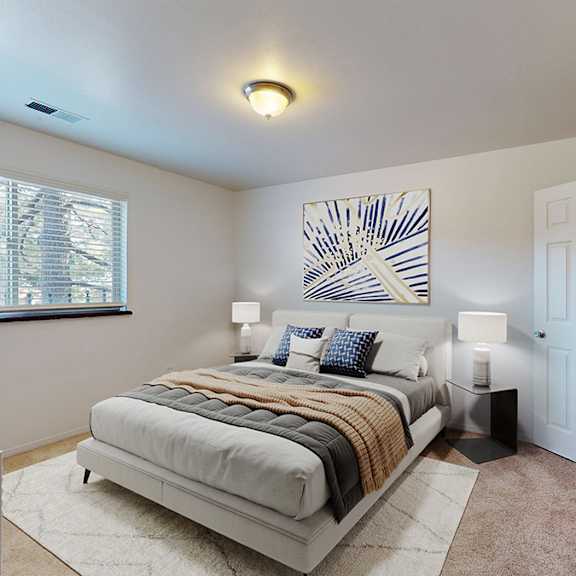 a bedroom with a large bed and a painting on the wall.