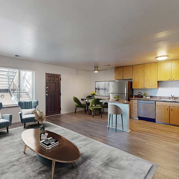 a modern living room with a grey rug and a coffee table in the middle.