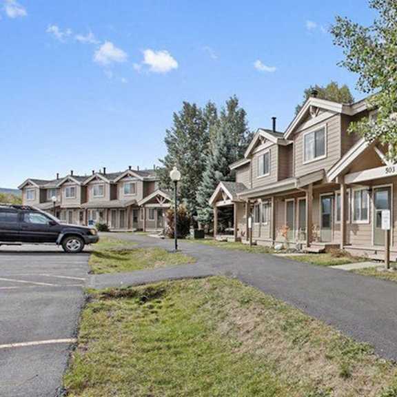 a residential area with houses and a car parked on the street.