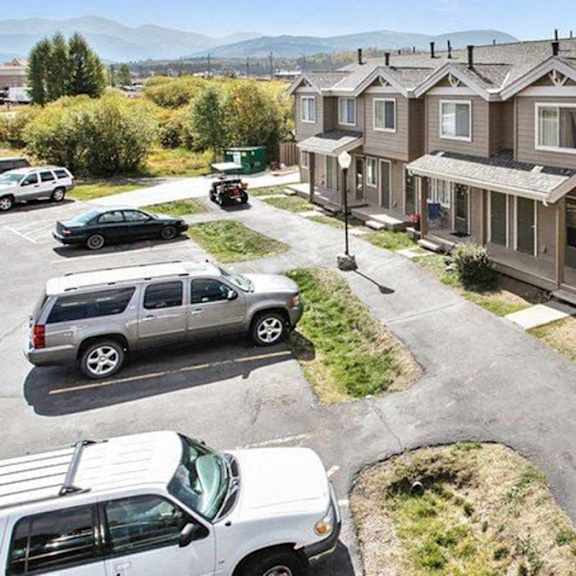 a residential area with houses and parked cars.