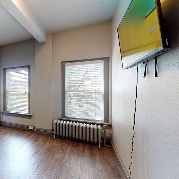 a room with wooden floors and a radiator.