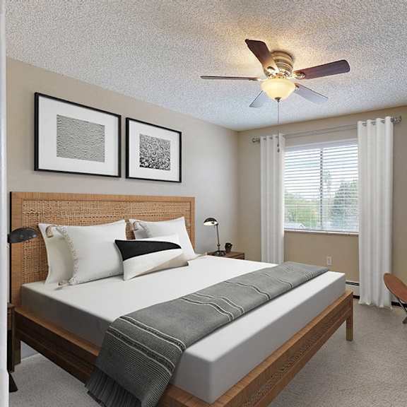 a bedroom with a bed, chair, and pictures on the wall.