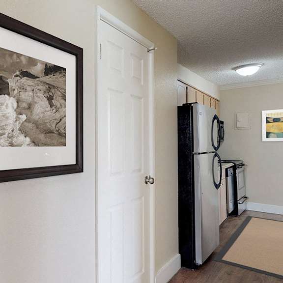 a black and white photograph is hanging on a white door.