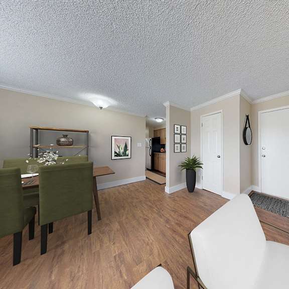a living room with a white chair and a green table.
