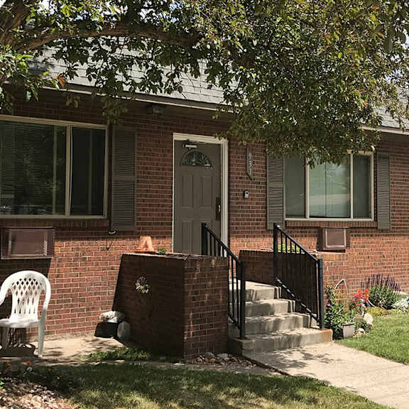 a house with a brick facade and a white door.