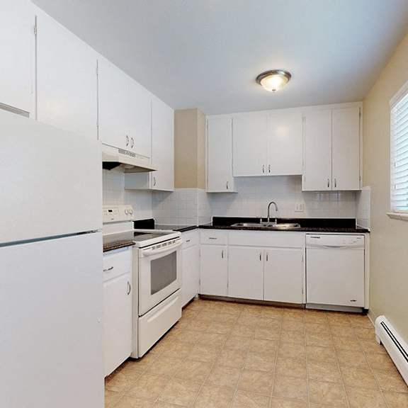 a kitchen with white appliances and cabinets.