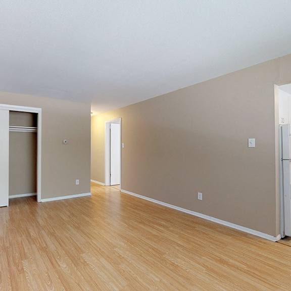 a room with a kitchenette and a refrigerator.