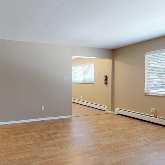 a room with wooden floors and white walls.