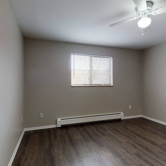 a room with a window and a ceiling fan.