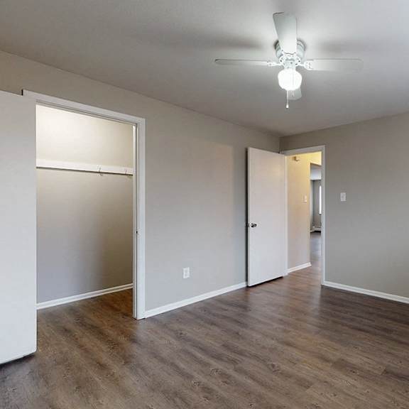 a room with a white door and a window with blinds.