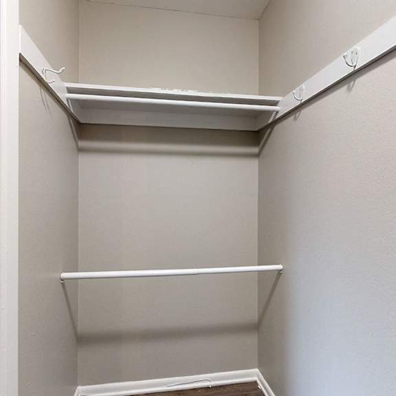 empty white refrigerator with two shelves.