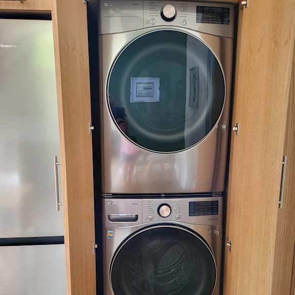 a washing machine and dryer in a cabinet.