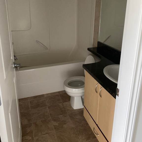 a bathroom with a toilet, sink, and bathtub.