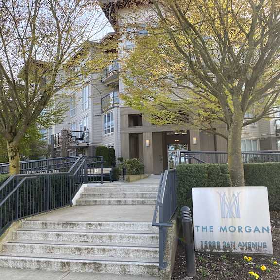 the morgan sign is in front of a building with stairs leading up to it.