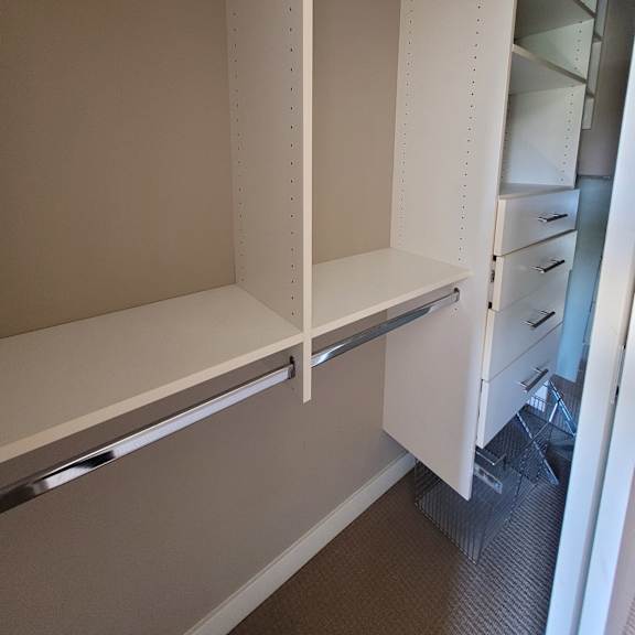 a white drawer with a silver handle is open.
