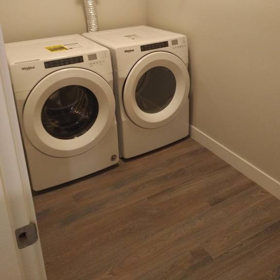 two washing machines in a laundry room.