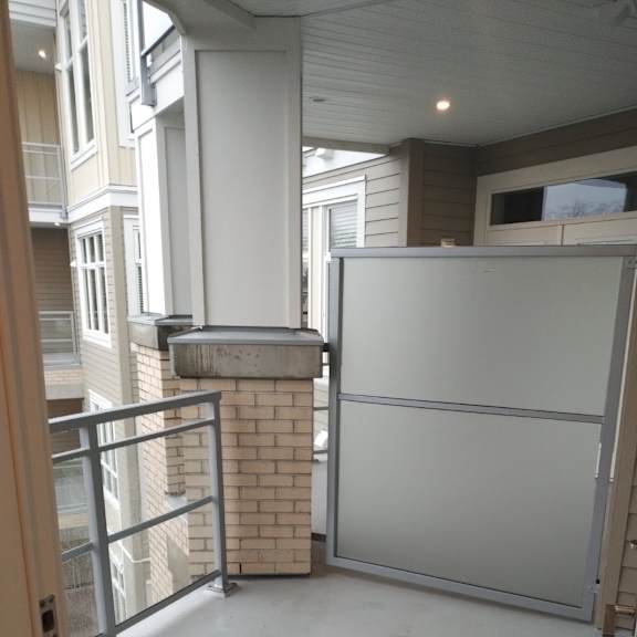 a white refrigerator in a room with a balcony.